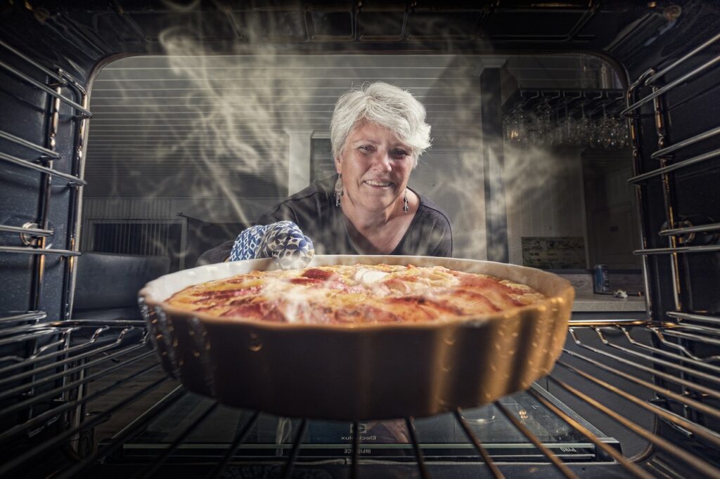 Elderly woman baking delicious fall treats.